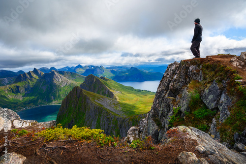 Hiker standing on the Husfjellet Mountain on Senja Island in northern Norway