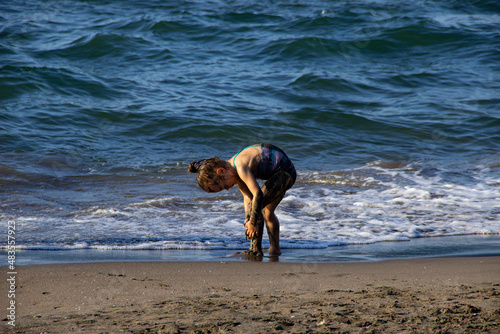 little girl playing on the beach