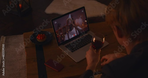 Two gays drinking wine and chatting during video call photo