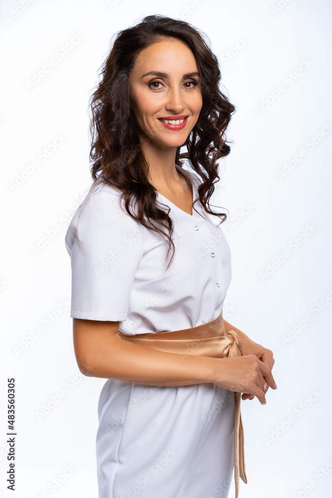 half-length portrait of a woman in a white overalls with a gold belt. girl in the studio. isolated white background half-length portrait of a woman in a white overalls with a gold belt. girl in the studio. isolated white background