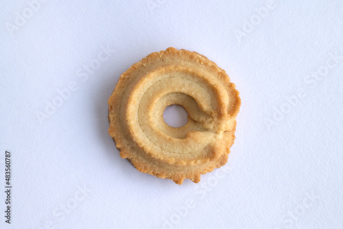 close up of Danish vanilla wreaths (vaniljekranse) cookies isolated on white background. homemade cracker in christmas traditional. yellow delicious bakery butter, top view