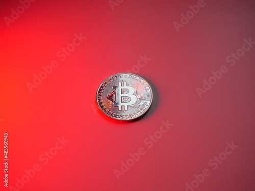 Bitcoin coin on red background. Cryptocurrency mining. Internet money