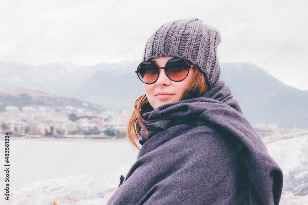 close-up portrait of a stylish fashionable woman in warm clothes on vacation