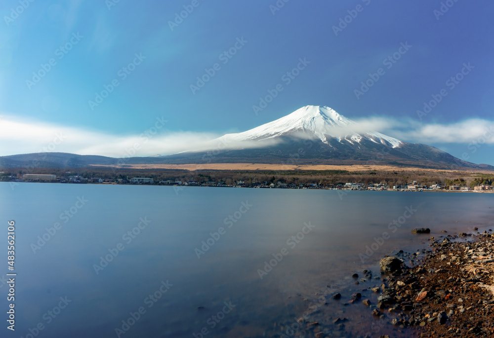 Mountain natural landscape beautiful background winter season. Mountain top snow and blue sky and blue water lake. Freezing water. Famous mountain Mt.Fuji In Japan