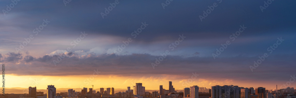 Dawn clouds over the metropolis of early sunset