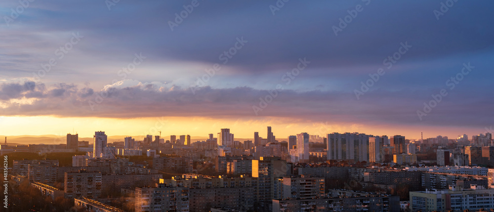 Dawn clouds over the metropolis of early sunset