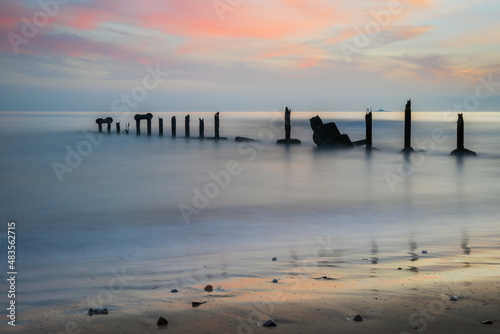 Long exposure image with old pillar stucture by Tagus river in Portugal at sunset © p_rocha