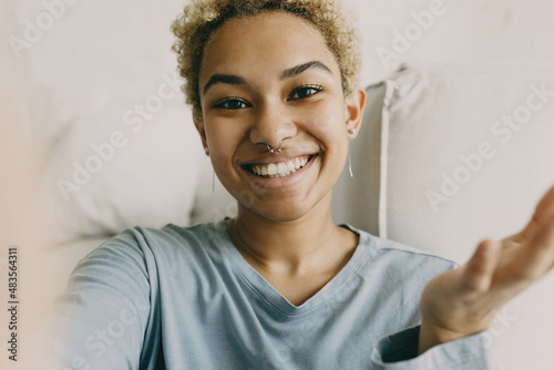 Cheerful hispanic girl smiling on camera. Bright strong emotion of happiness. Latino american woman with cool nose piercing. Beauty of youth, facial expression, joy concept