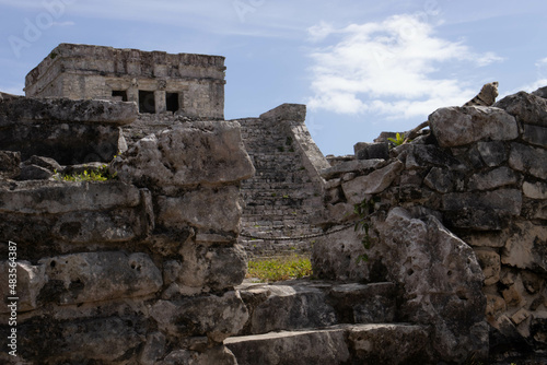 Background of the Tulum castle, this is a Mayan ruin located on the beach of Tulum along the Riviera Maya being visited by many tourists on vacation in Mexico, next to the Caribbean Sea.