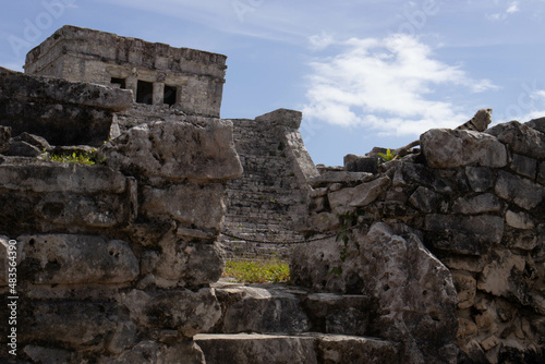 Beautiful photo of the Tulum castle, this is a mayan ruin located on the Tulum beach along the Riviera Maya being visited by many tourists on vacation in Mexico, next to the caribbean sea.