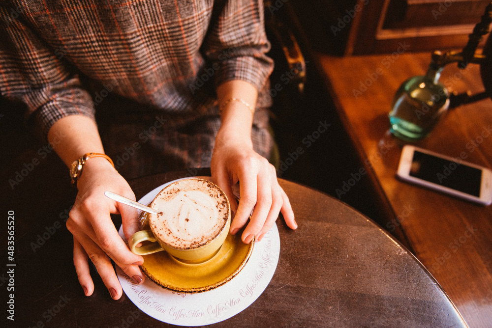 a cup of coffee and a woman's hands a cup of coffee and a woman's hands