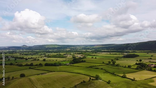 Drone hyperlapse over patchwork fields in North York Moors with clouds photo