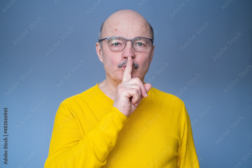 Senior hispanic man in glasses making silent Senior hispanic man in glasses making silent