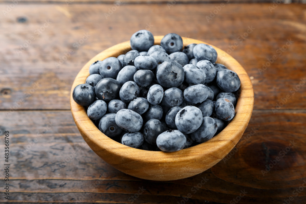 Blueberry berries are in a wooden plate on wooden background. Healthy food and healthy lifestyle. Blueberry berries are in a wooden plate on wooden background. Healthy food and healthy lifestyle.