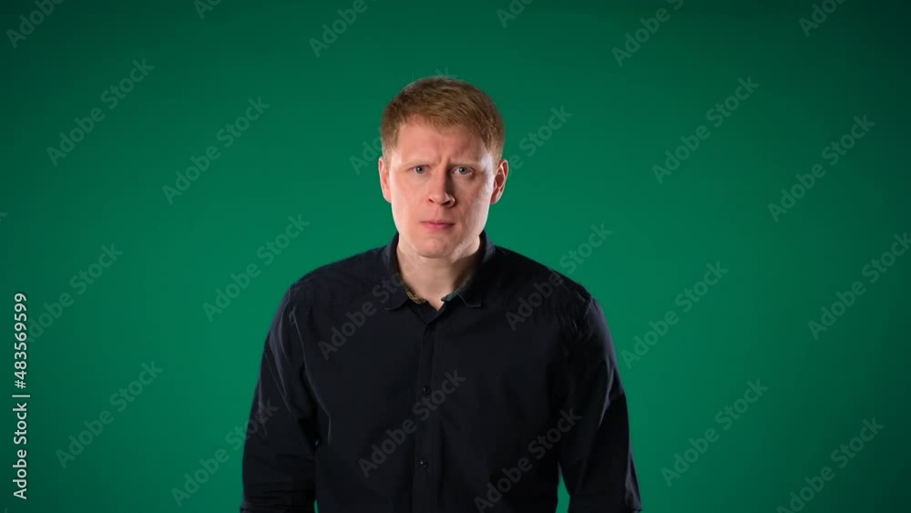 Red-haired middle-aged man in a black jacket angry. He imitates anger Red-haired middle-aged man in a black jacket angry. He imitates anger