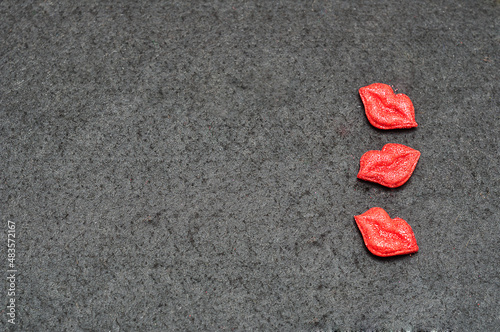 Three candy lips isolated on a black background