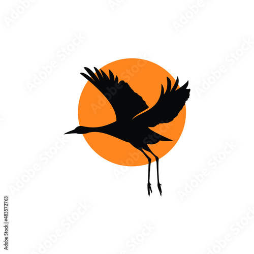 silhouette of flying heron egret crane and sunset logo design