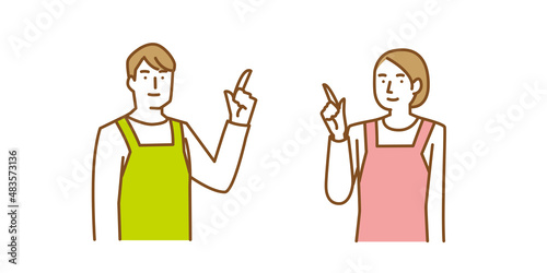 上を指差し案内をするエプロン姿の男性と女性