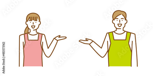 片手をあげて笑顔で案内をするエプロン姿の男性と女性