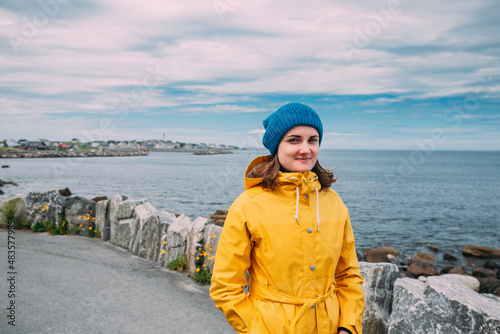 Alnesgard, Godoya, Norway. Portrait Of Young Caucasian Woman Lady Tourist Traveler In Summer Day In Godoy Island Near Alesund Town. photo