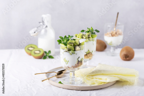 Homemade yogurt with fresh kiwi, muesli and mint