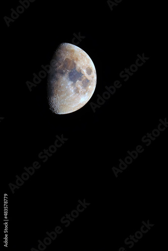 Growing colored mineral moon on a black background .