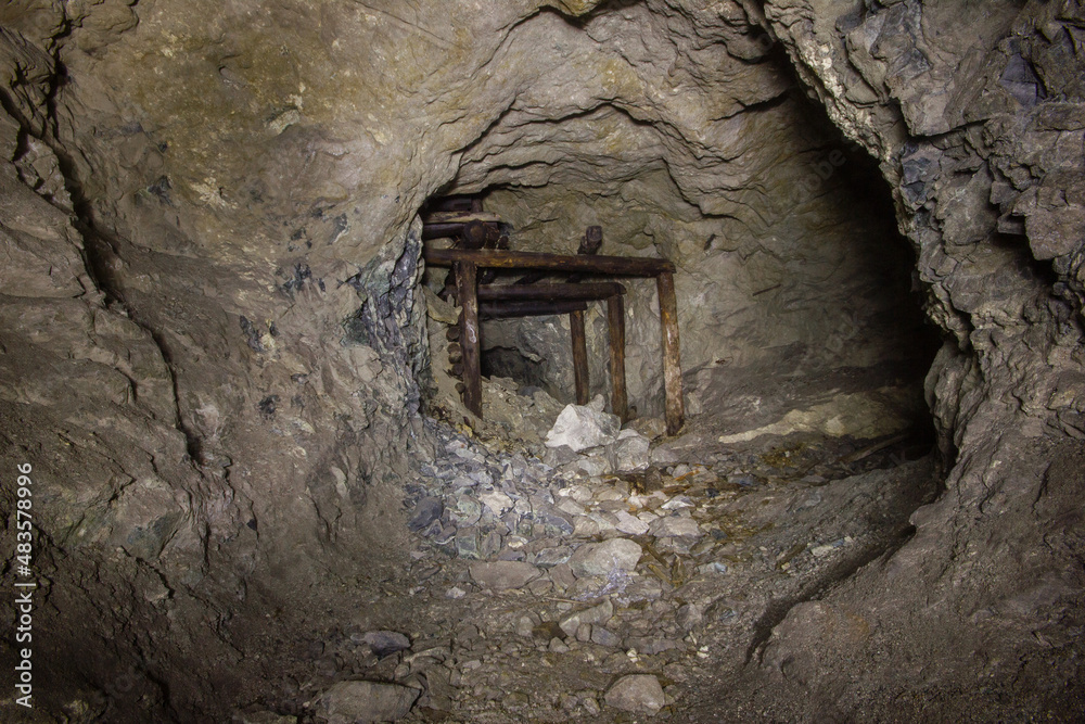 Underground gold mine tunnel with wooden timbering