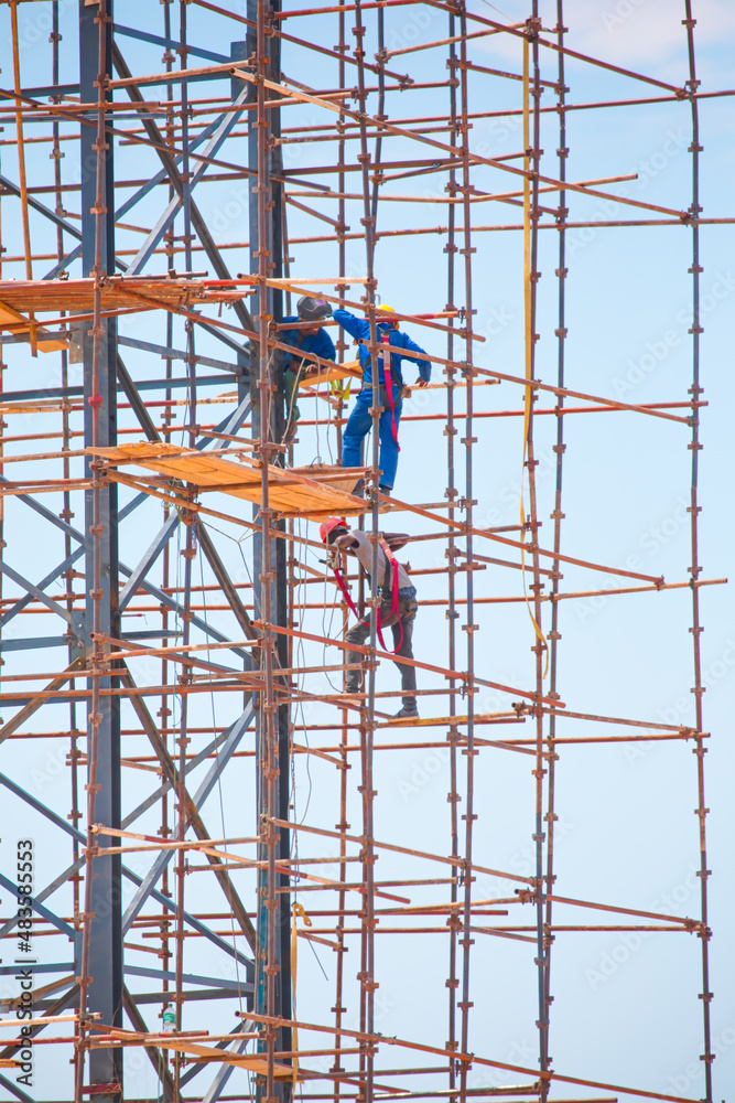 A group of workers constructing a water tank - Namibia, Africa A group of workers constructing a water tank - Namibia, Africa