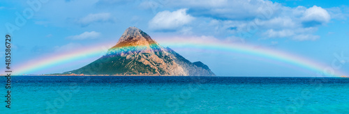 Tavolara Island, scenic view of island and full rainbow in a unique moment