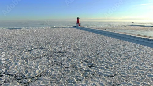 Looking down on water surface covered in pancake ice by Lighthouse. Pancake ice forms when the water is cold enough to freeze, but is moving too much with waves, for a solid ice surface to form. photo