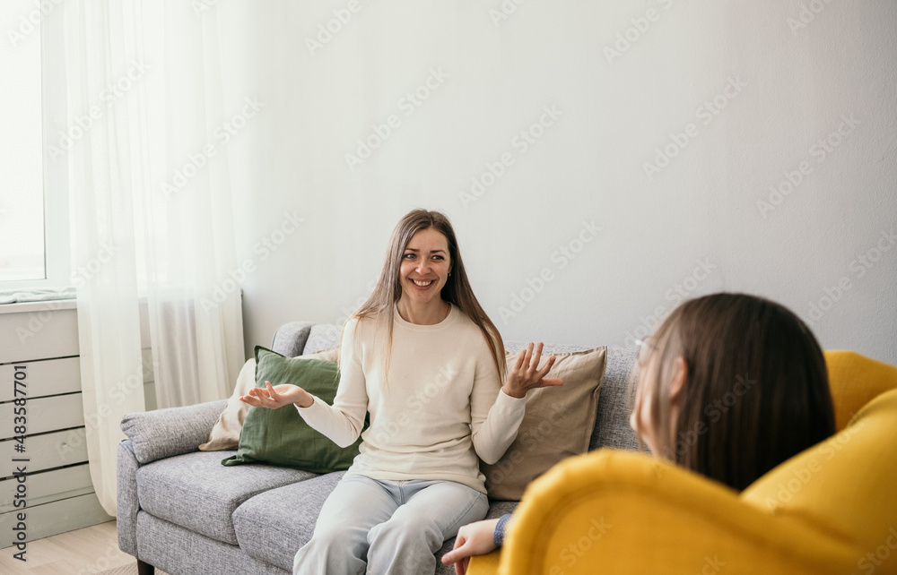 a successful course of psychotherapy. a happy woman patient tells a psychologist about her successes a successful course of psychotherapy. a happy woman patient tells a psychologist about her successes