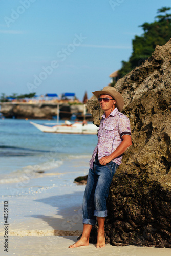 young man is resting on the sea. A man on the seashore. Tropical climate. Exotic nature. 