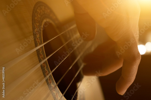 Play the guitar. Man plays acoustic guitar, close up