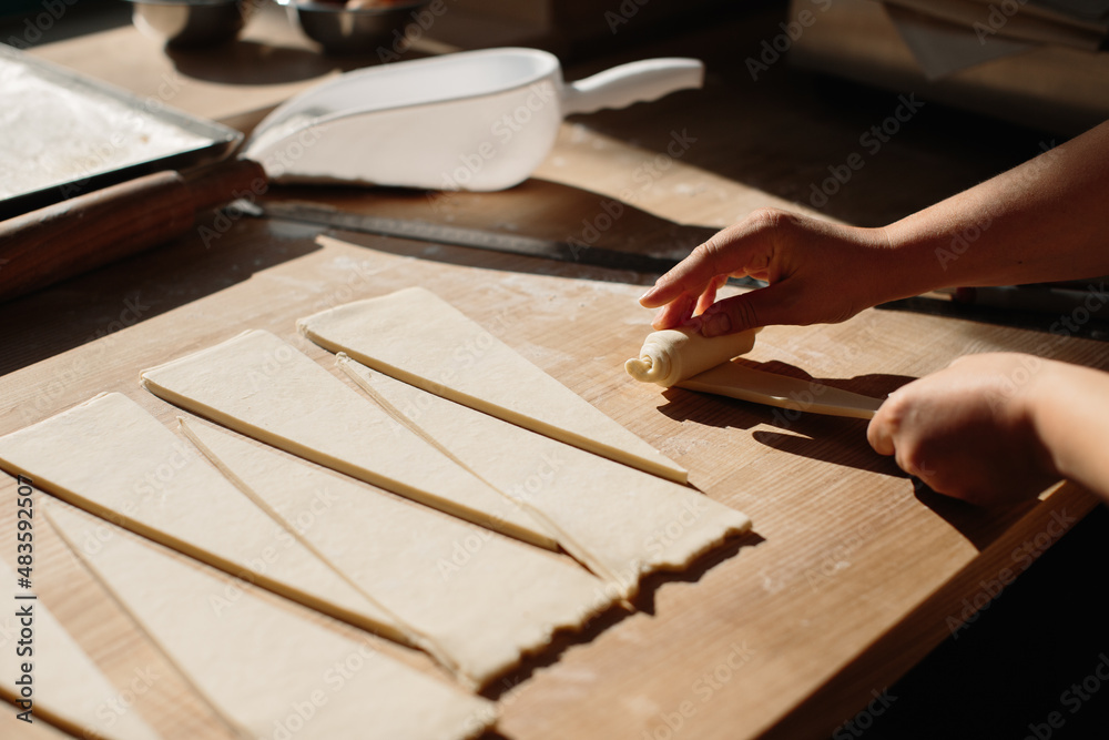 Female Hands Rolling Dough into Rolls, Baking Process Making Croissant. Selected Focus, Concept for Bakery Female Hands Rolling Dough into Rolls, Baking Process Making Croissant. Selected Focus, Concept for Bakery