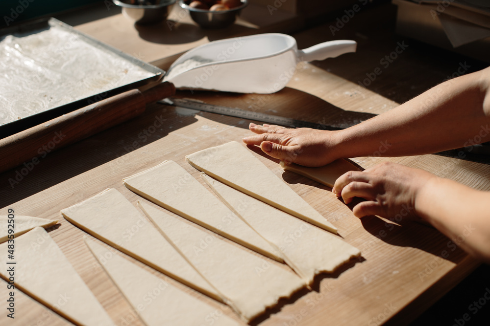 Female Hands Rolling Dough into Rolls, Baking Process Making Croissant. Selected Focus, Concept for Bakery Female Hands Rolling Dough into Rolls, Baking Process Making Croissant. Selected Focus, Concept for Bakery