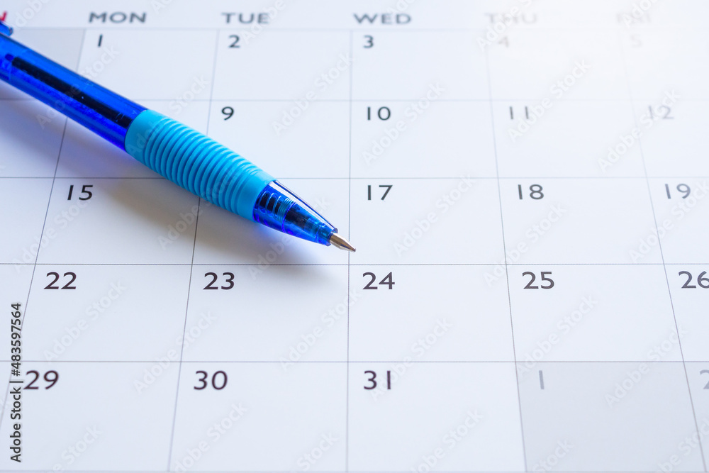 Blue pen on calendar page background business planning appointment meeting concept Blue pen on calendar page background business planning appointment meeting concept