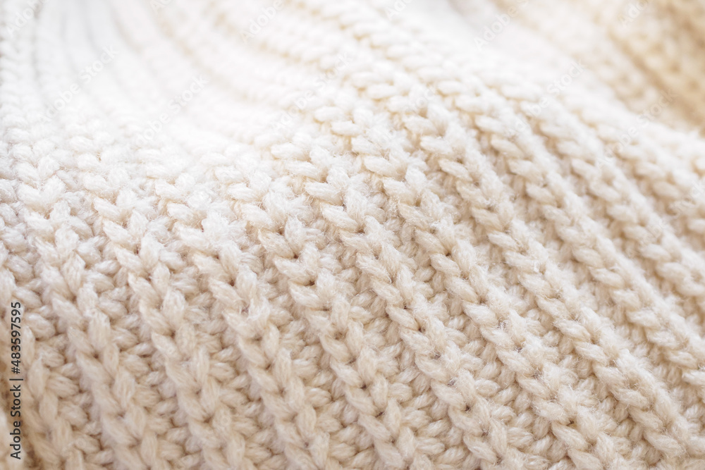 closeup beige knitted woolen fabric texture background closeup beige knitted woolen fabric texture background