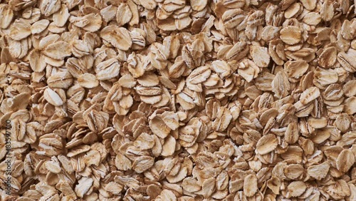 Raw oatmeal flakes texture background move slow