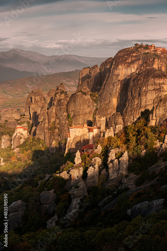 Atmospheric distant view of the Monastery of Rousanou Agias Barbaras in Meteora. Tourist and pilgrimage inspirations. Natural and religious wonders of Greece.