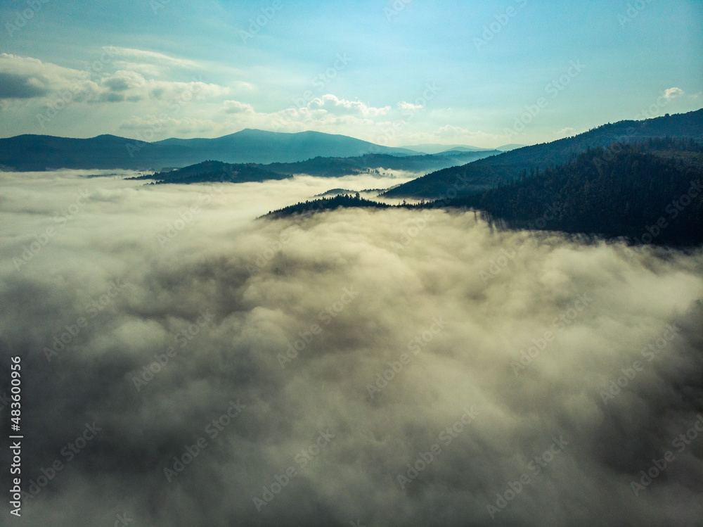 Aerial view of clouds and fog over mountains hills