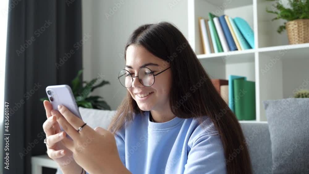 Happy female teenager video chatting with friend using smartphone waving hand, greeting sharing good news best friends enjoying long distance communication. 4k footage Happy female teenager video chatting with friend using smartphone waving hand, greeting sharing good news best friends enjoying long distance communication. 4k footage