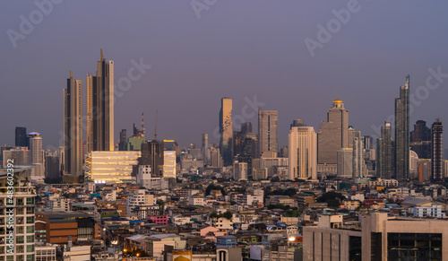 Aerial view of Sathorn, Bangkok Downtown skyline. Financial district and business centers in smart urban city town in Asia. Skyscraper and high-rise buildings at night.