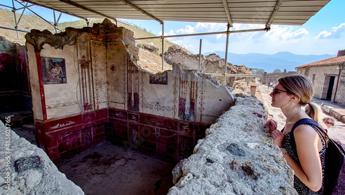 women in Pompeii, looking to rouins of ancient city, Italy photo