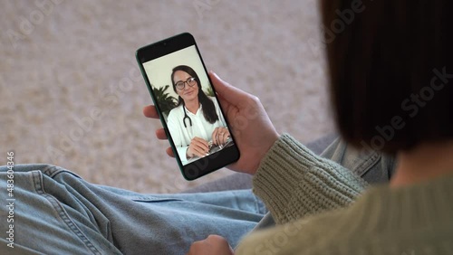 Female patient talking doctor on smartphone by video calling, distance consulting with psychotherapist in white coat . Telemedicine, remote healthcare services concept. Vertical view. 4k footage