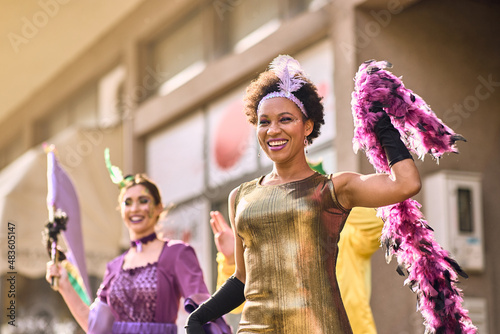 Stampa su tela Cheerful black woman has fun on Mardi Gras street carnival while wearing a costume