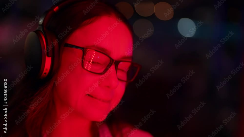 portrait of middle-aged woman with wireless headphones on head, smiling lady is enjoying music portrait of middle-aged woman with wireless headphones on head, smiling lady is enjoying music