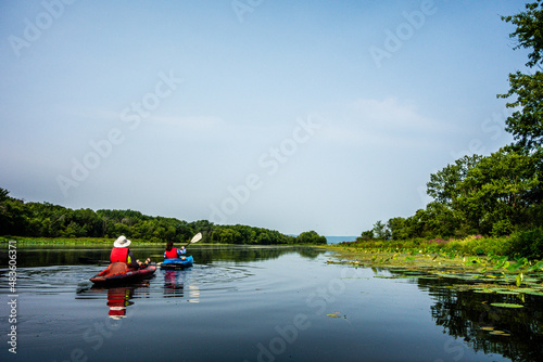 family kayaking on the river