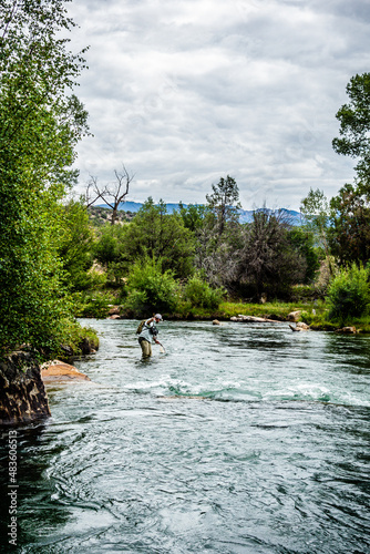 woman fly fishing in a mountain stream