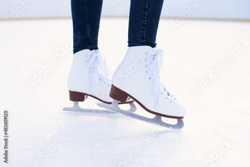 woman is ice skating on rink close up