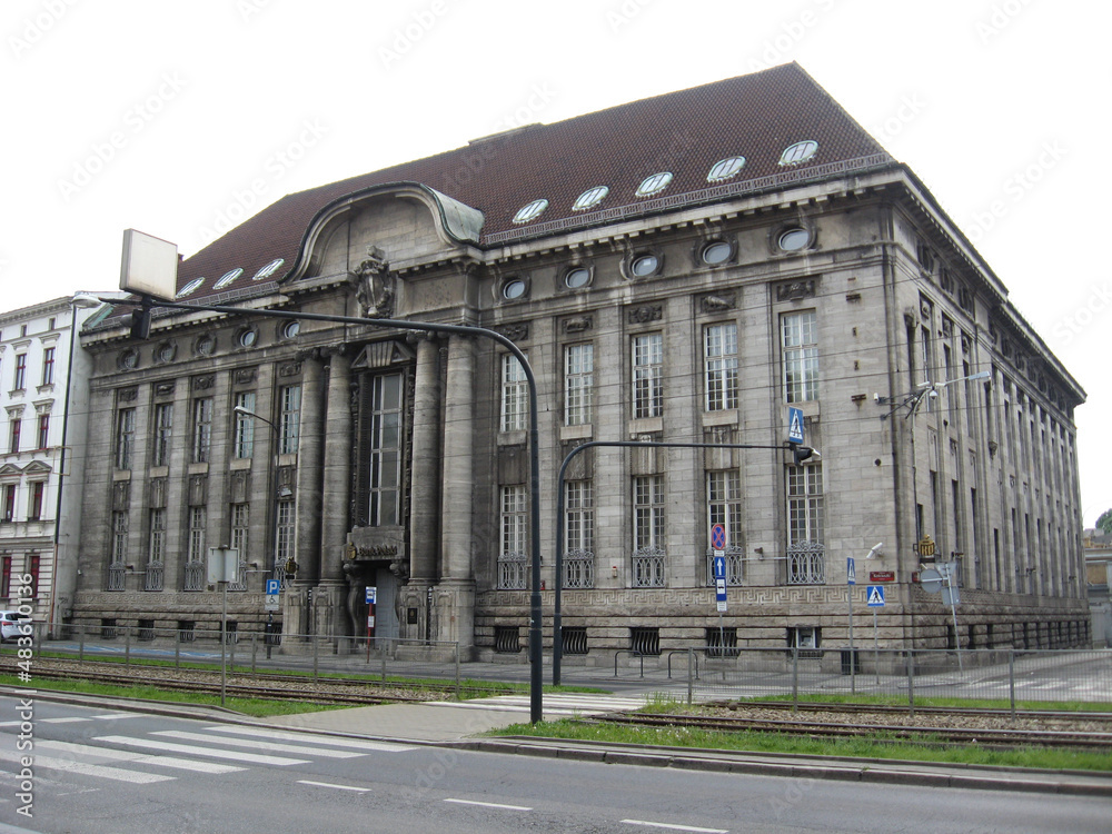 Naklejka premium Modern architecture in Lodz. Building with dark glass windows. Office building